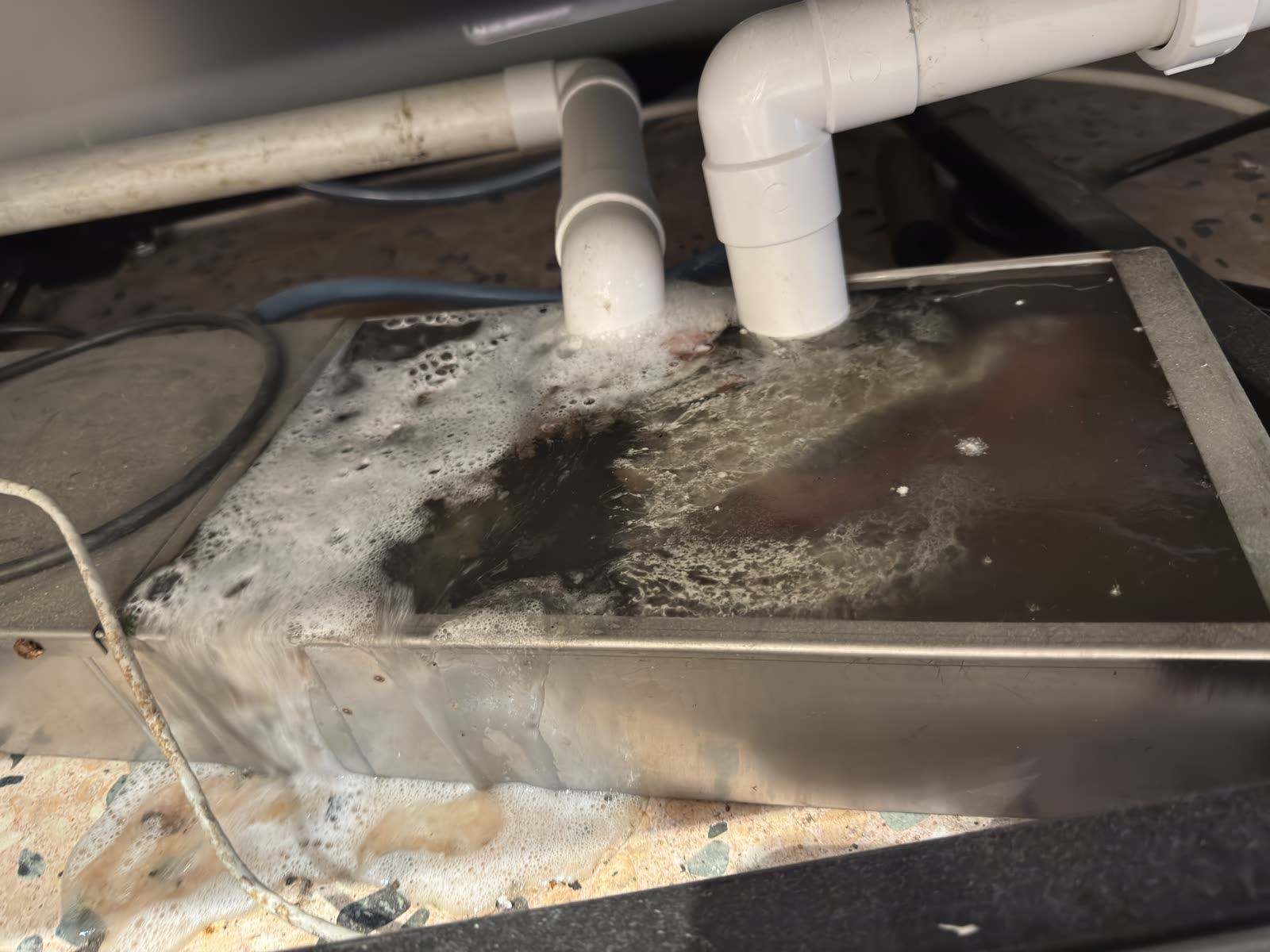 Condensate drain — emptied before clean